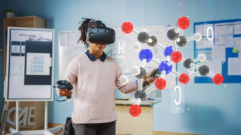 Girl using VR headset to look at structure of a molecule